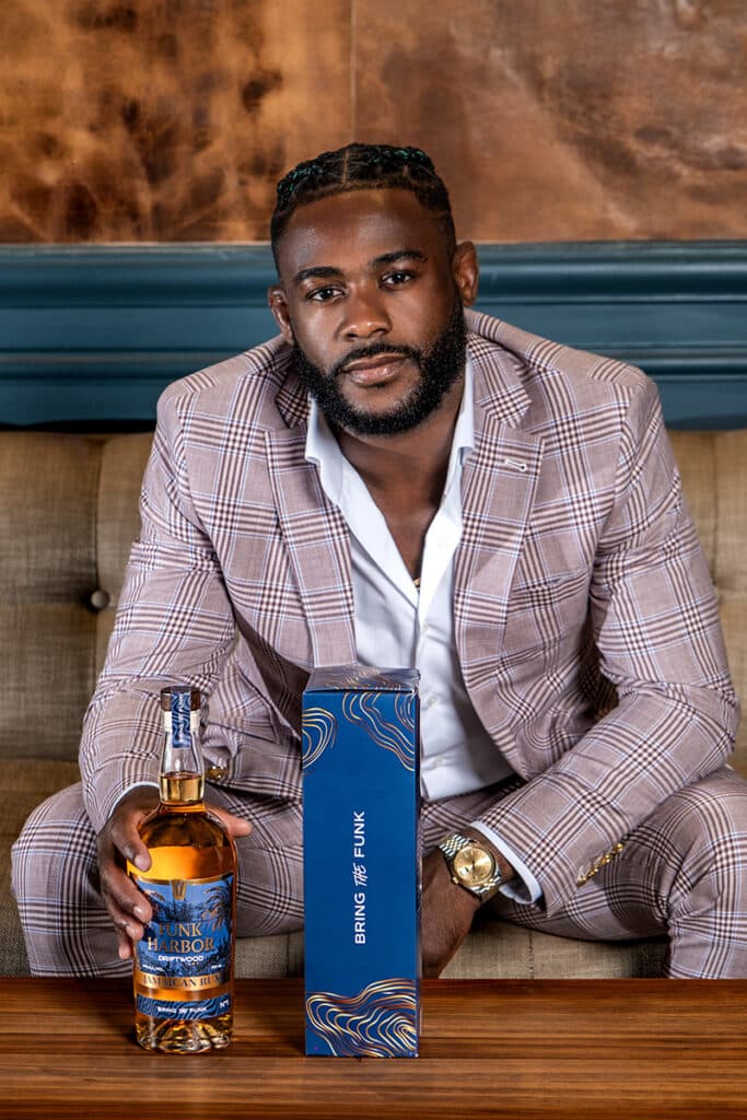 Aljamain Sterling with a bottle of Funk Harbor Rum